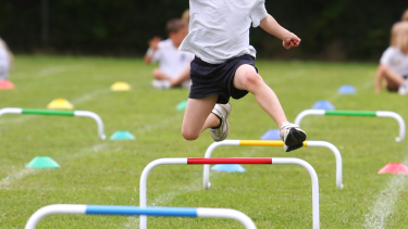 child doing hurdles