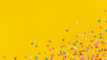 colourful star confetti on yellow background
