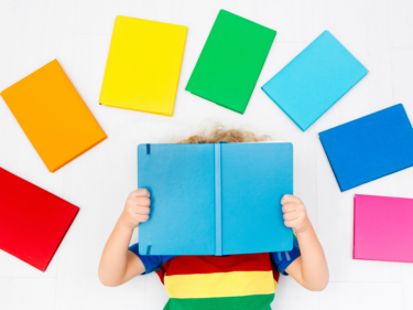 rainbow of books above a child reading