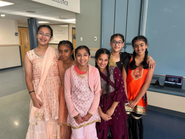 Group of female middle school students in traditional attire celebrating Diwali
