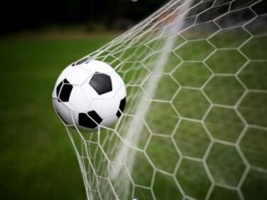 soccer ball going into soccer net