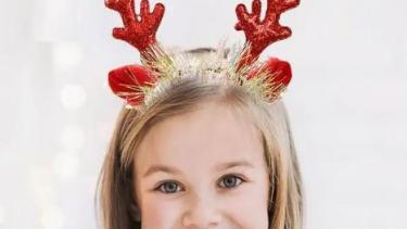child wearing antlers