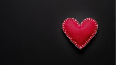 red heart on black background