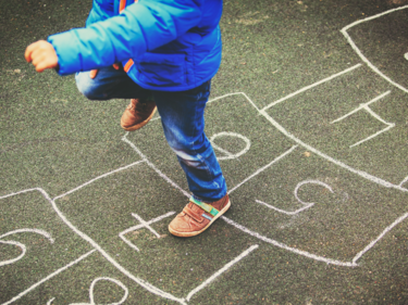 child doing hopscotch