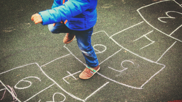 child doing hopscotch