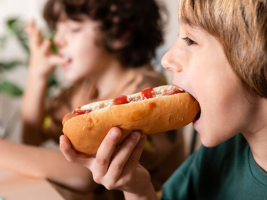 kid eating hot dog