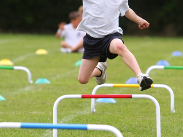 child doing hurdles