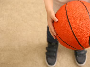 child holding basketball